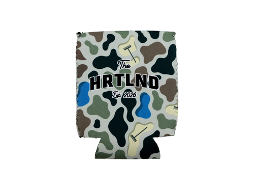 A custom neoprene can cooler featuring a green, brown, and black camouflage pattern with golf club illustrations and the text 'The HRTLND For. 2026' printed on the front, shown against a plain white background.