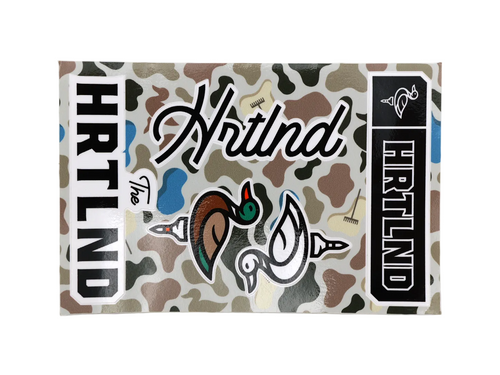 A rectangular HRTLAND branded sticker or decal sheet featuring a woodland camouflage pattern with duck illustrations and bold black-and-white text panels.